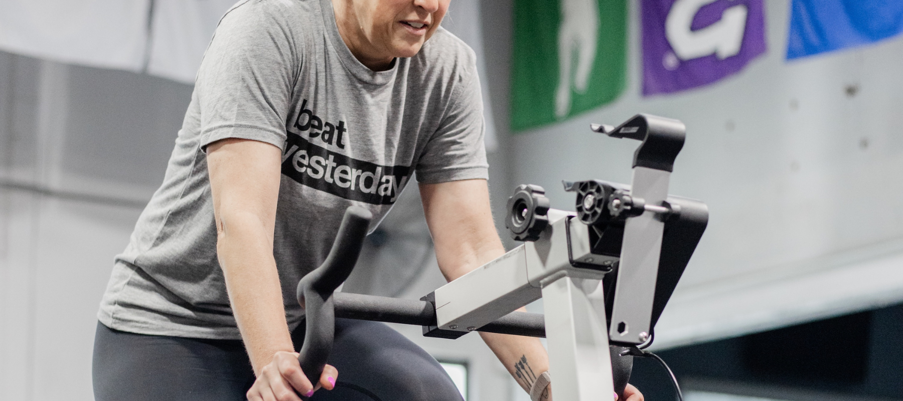 Female Athlete on bike wearing Beat Yesterday shirt